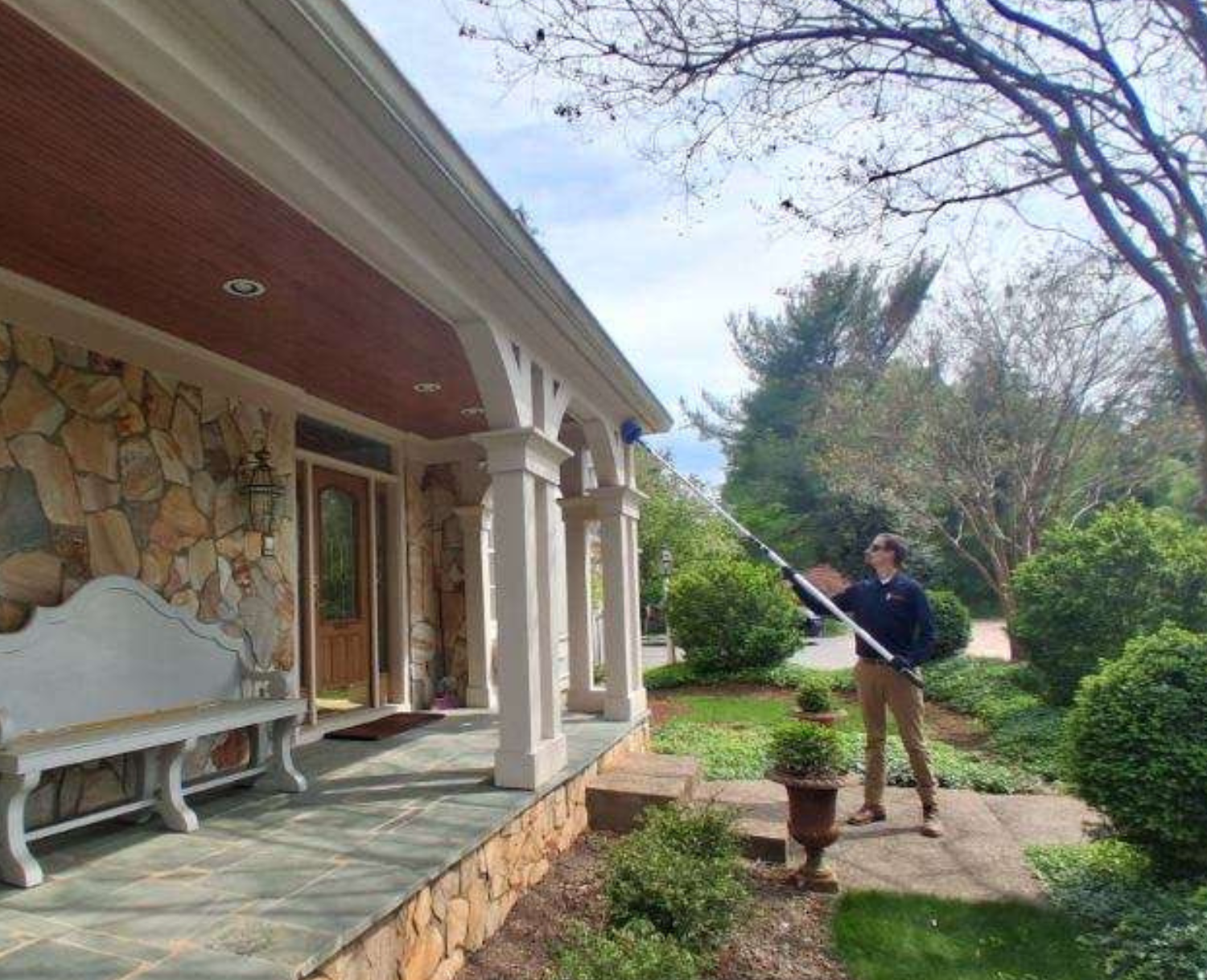 Untitled design (17) A man works in the garden, spraying weeds from a sprayer.<br />