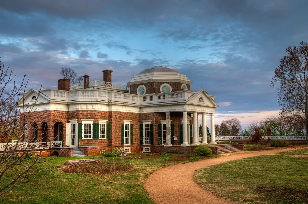 image - 2025-04-23T224101.335 3. Large brick house facade showcasing a striking dome structure above.
